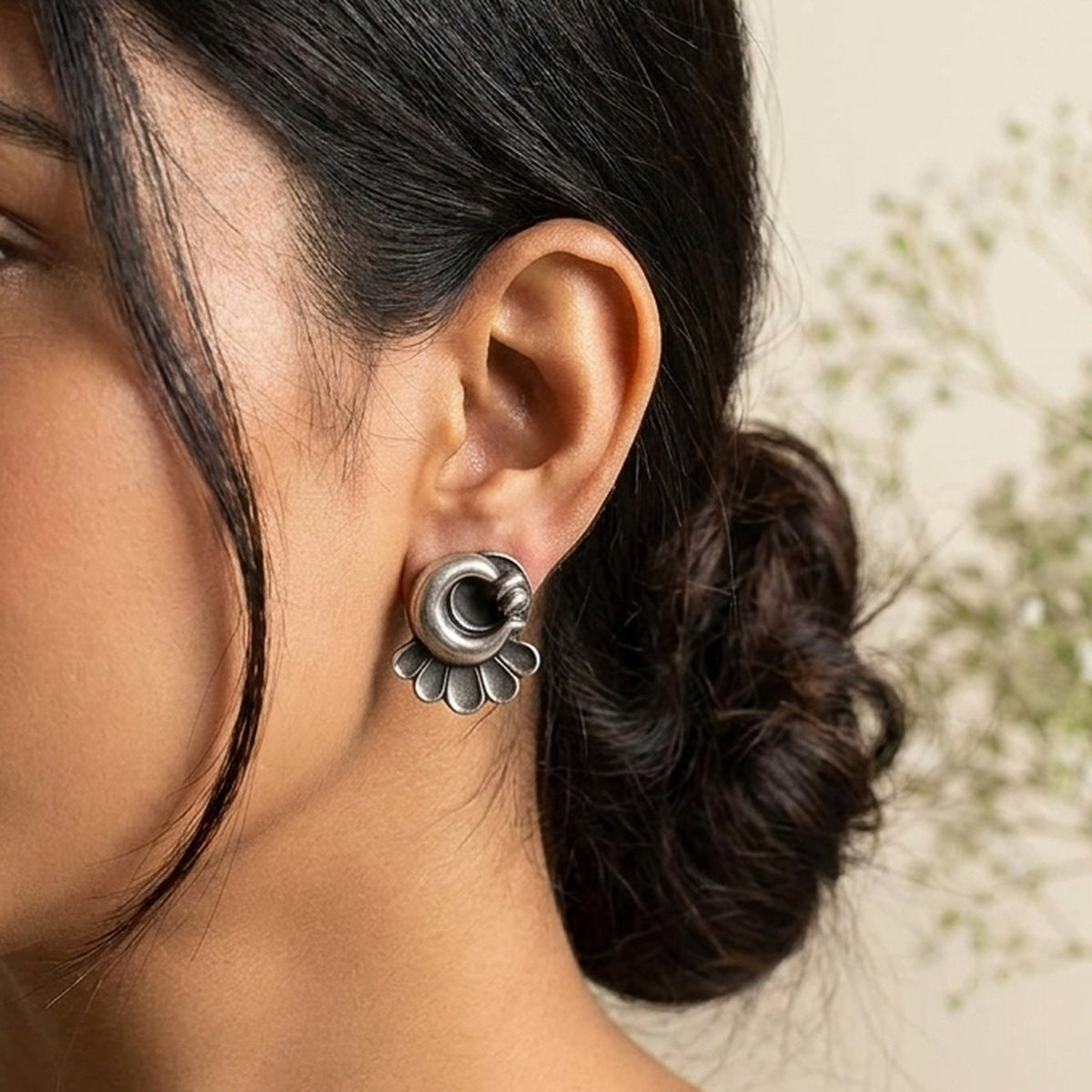 Silver Blossom Petite Studs worn on the ear, handmade by Dream Karigiri