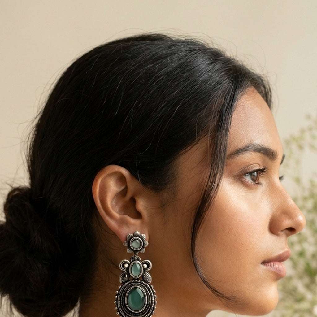 Emerald Oval Oxidised Drop Earrings worn on the ear, handmade by Dream Karigiri
