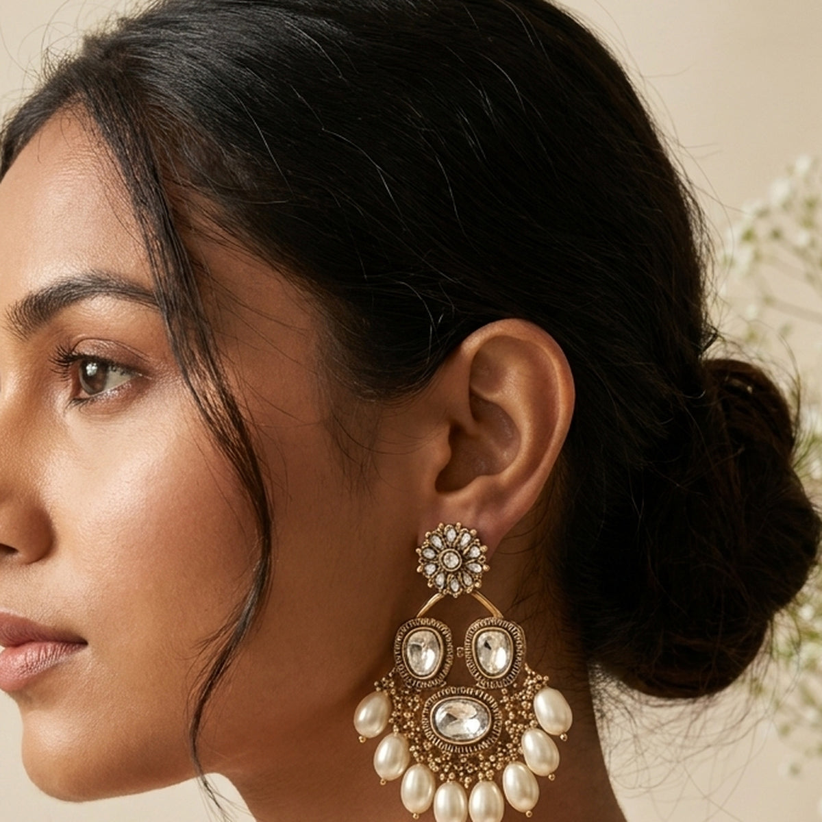 Golden Chandbali Pearl Earrings worn on the ear, handmade by Dream Karigiri