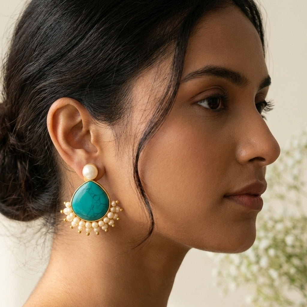 Golden Turquoise Drop Earrings worn on the ear, handmade by Dream Karigiri