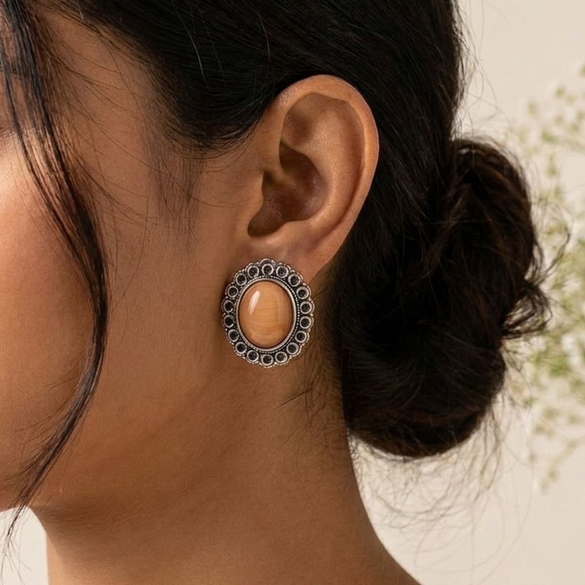 Coral Orange Oval Studs worn on the ear, handmade by Dream Karigiri