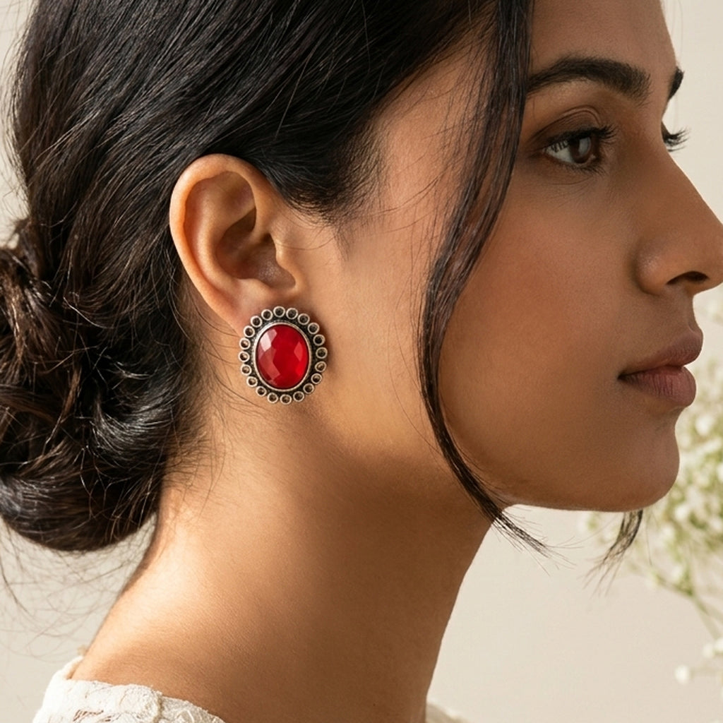 Ruby Red Oval Silver Studs worn on the ear, handmade by Dream Karigiri