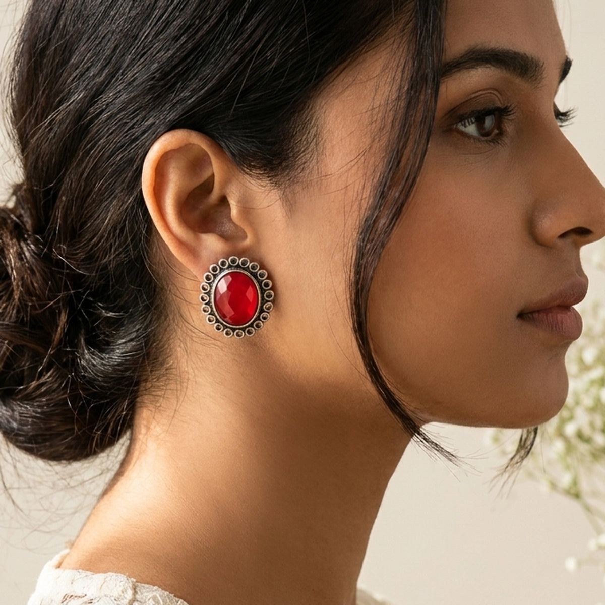 Ruby Red Oval Silver Studs worn on the ear, handmade by Dream Karigiri