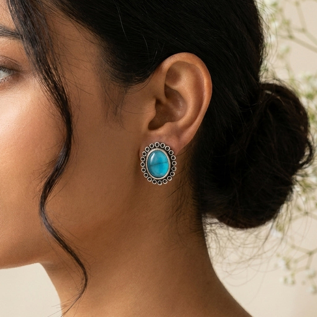Sky Blue Oval Silver Studs worn on the ear, handmade by Dream Karigiri