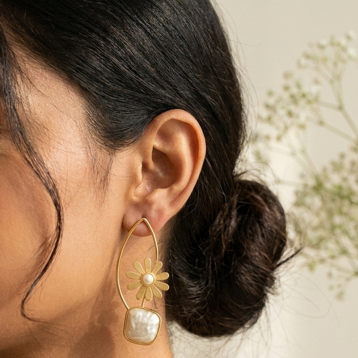 Golden Daisy Pearl Drop Earrings worn on the ear, handmade by Dream Karigiri