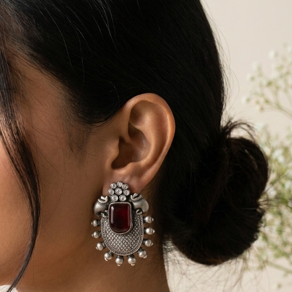 Meenakshi Maroon Drop Earrings worn on the ear, handmade by Dream Karigiri