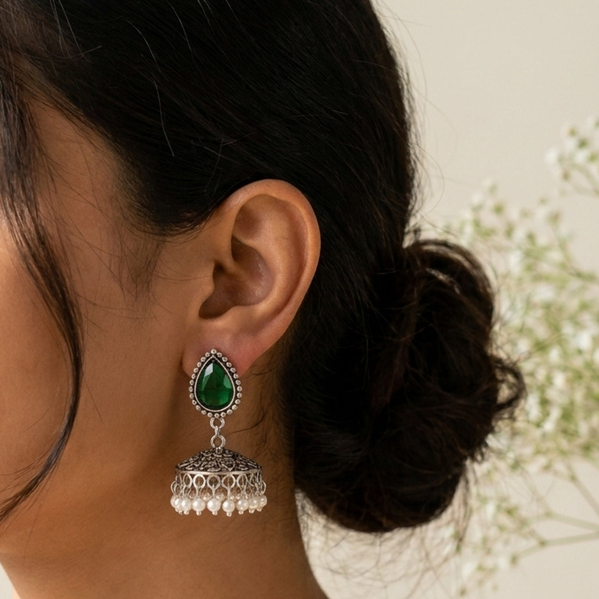 Emerald Meena Teardrop Jhumkas worn on the ear, handmade by Dream Karigiri