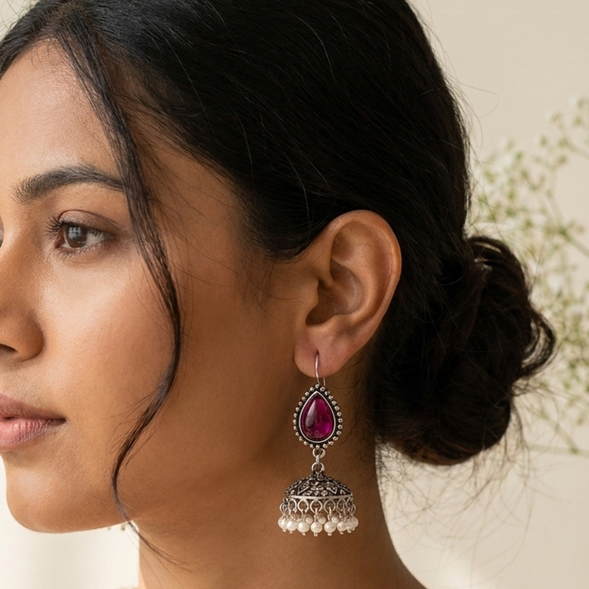 Rani Pink Teardrop Jhumkas worn on the ear, handmade by Dream Karigiri