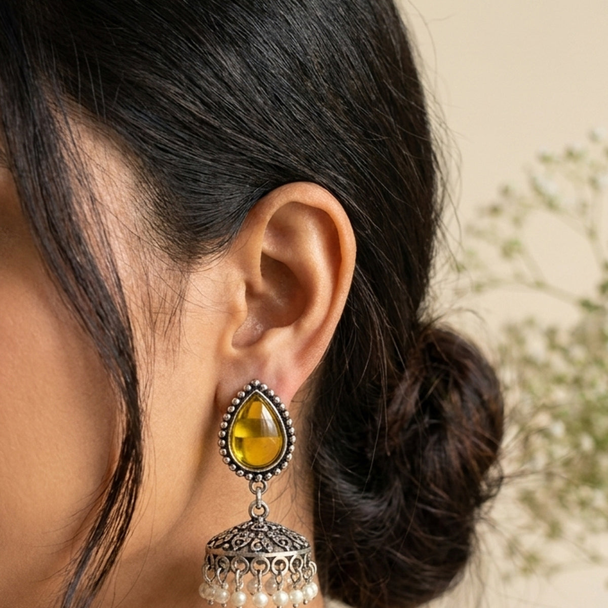 Haldi Yellow Teardrop Jhumkas worn on the ear, handmade by Dream Karigiri