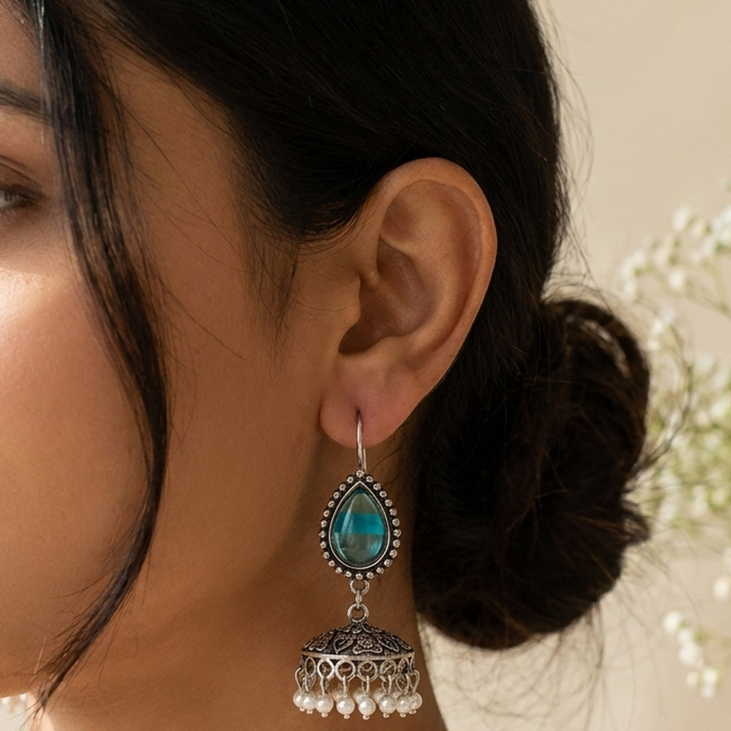 Firoza Blue Teardrop Jhumkas worn on the ear, handmade by Dream Karigiri