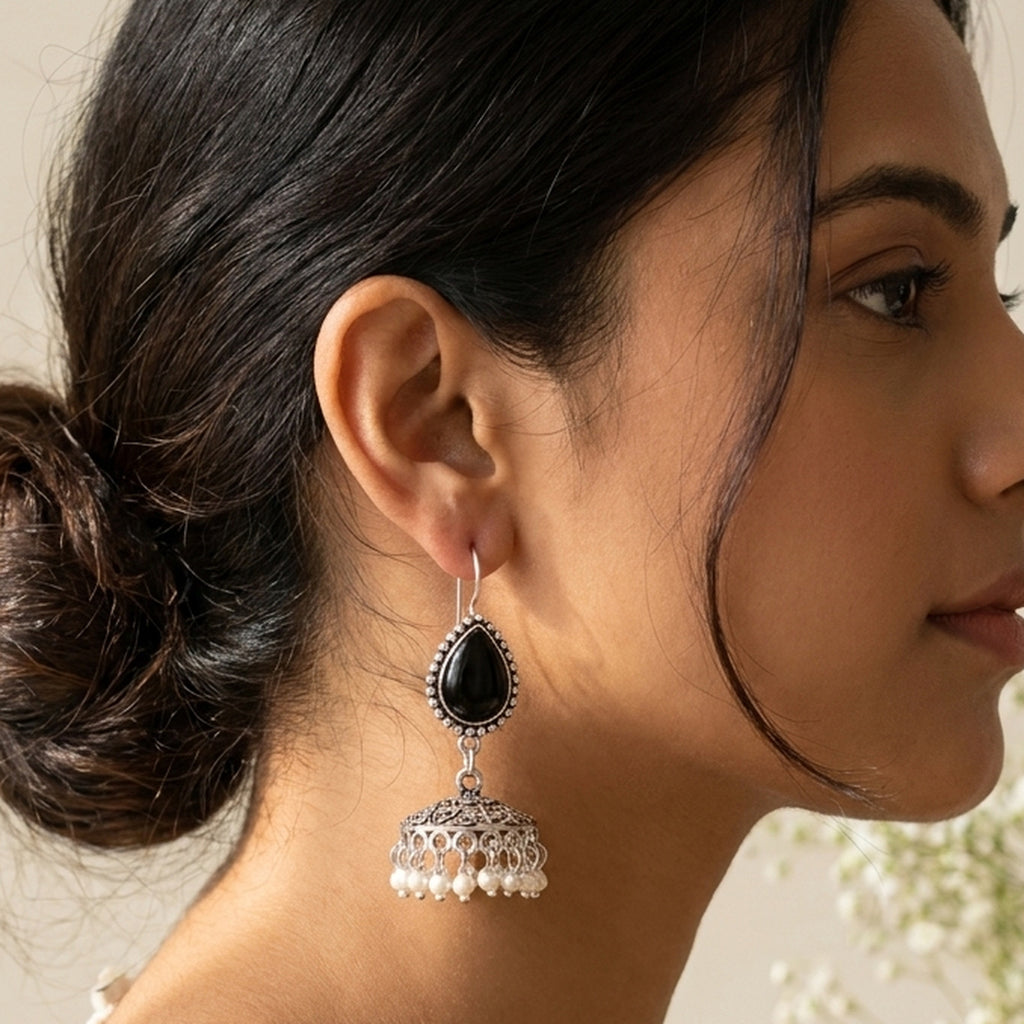 Kaajal Black Teardrop Jhumkas worn on the ear, handmade by Dream Karigiri