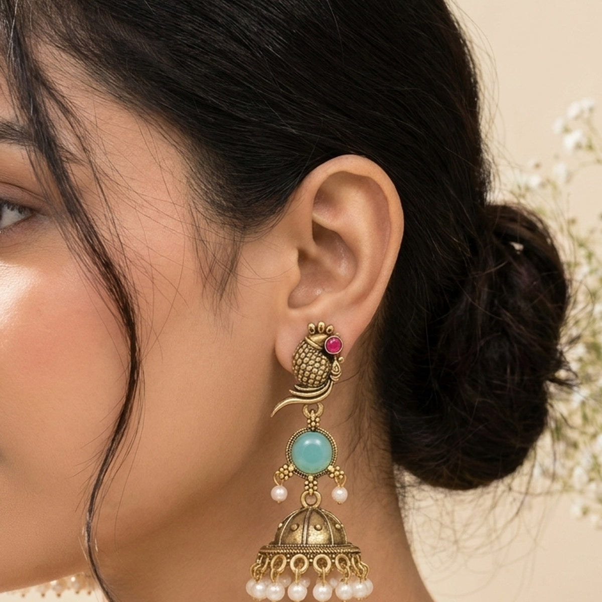 Oxidized Golden Peacock Jhumka - Turquoise worn on the ear, handmade by Dream Karigiri